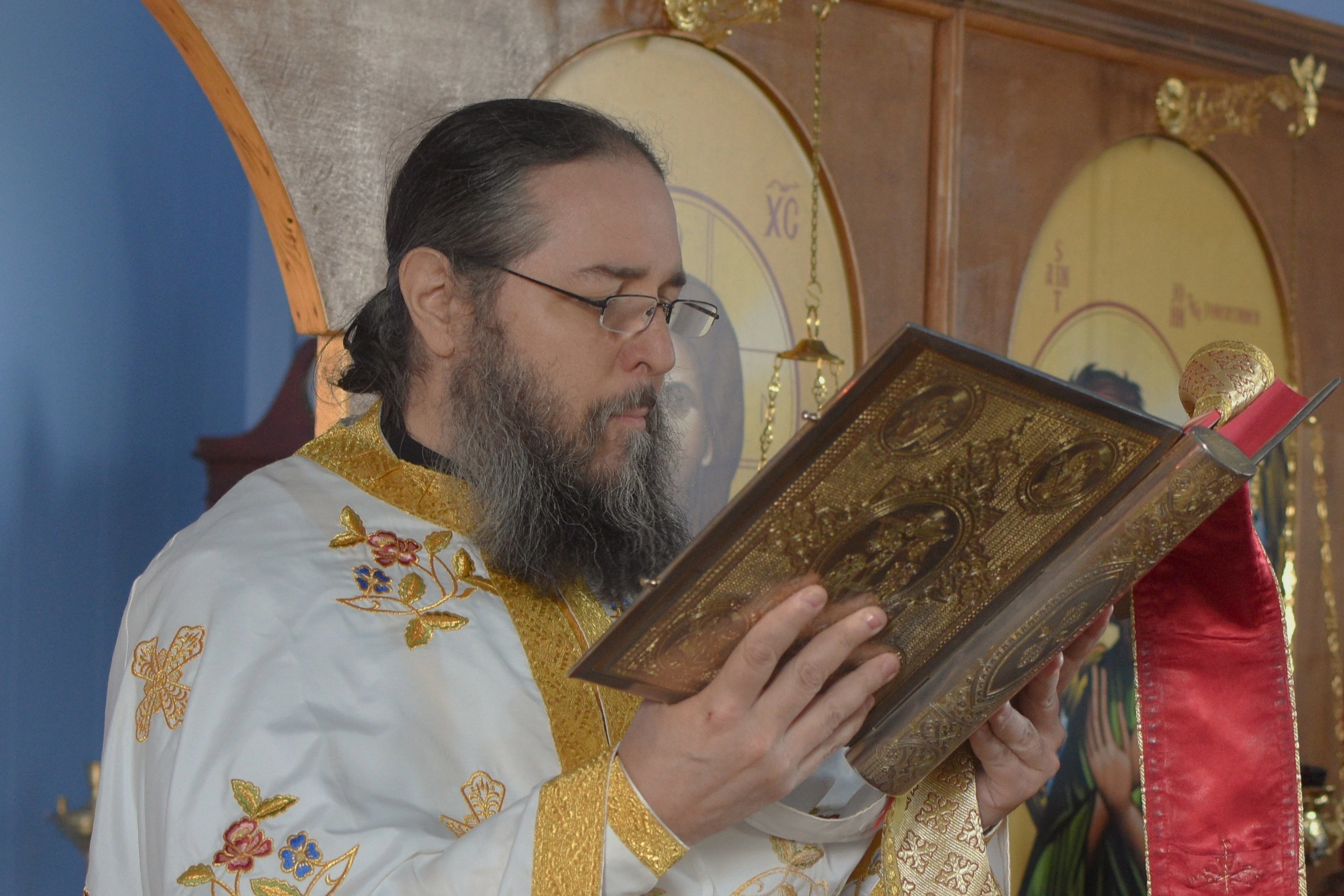 Father John reading the Gospels